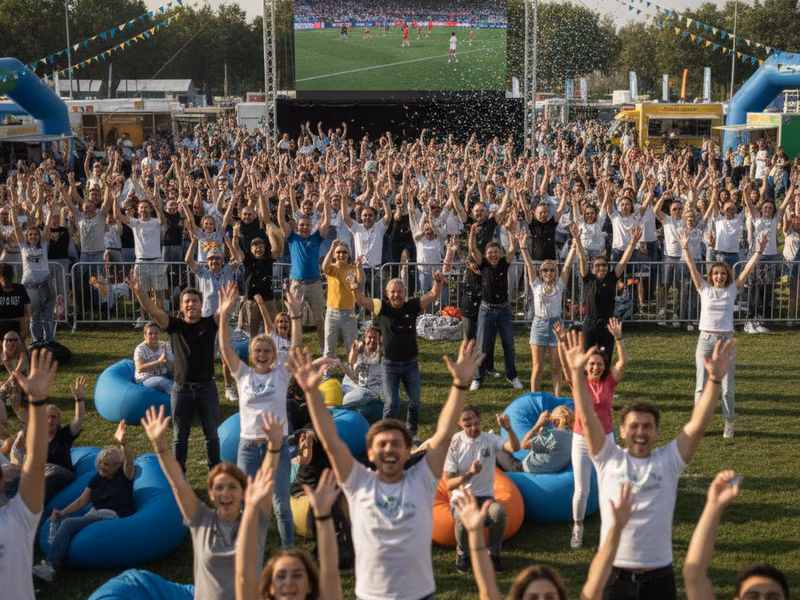 Fans cheering in the fan zone at a community sports event